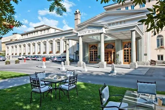 Kulm Hotel St. Moritz at dusk, 5-star transfer service by comforttransfer